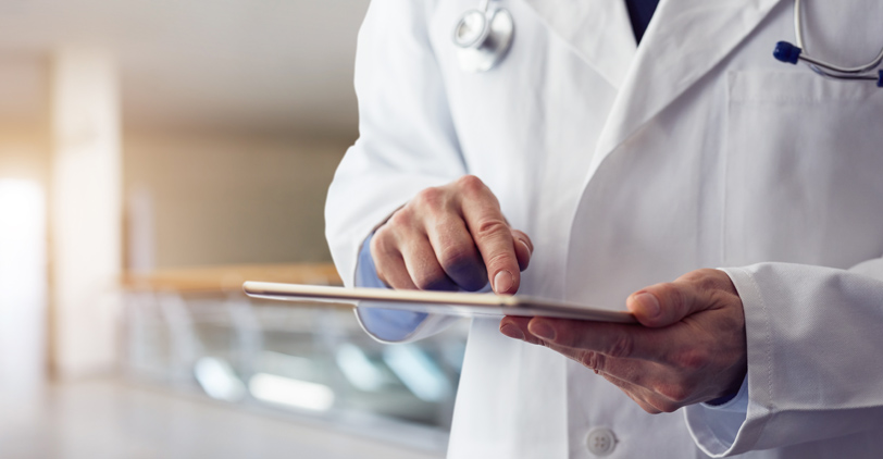Healthcare worker entering billing information into tablet computer