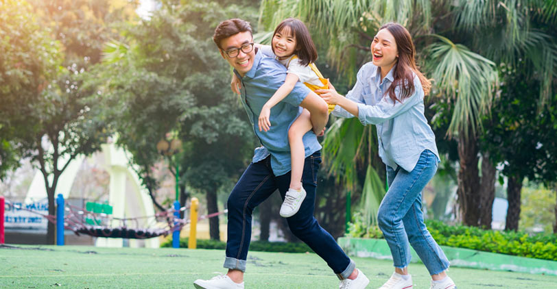 Mother and father playing with their child