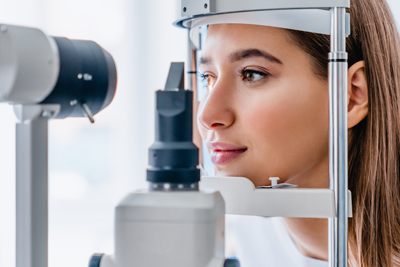 A young woman receiving a vision test