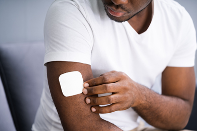 a man with a nicotine patch on his arm