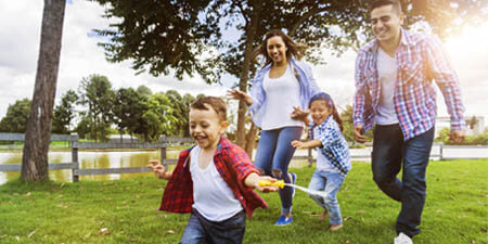 Happy family outside on a sunny day having fun
